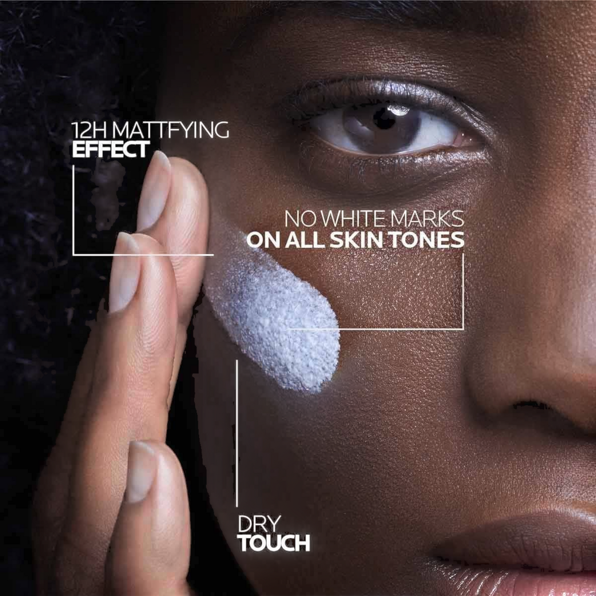 Lumina Pharmacy La Roche-Posay Anthelios sunscreen applied to a model's cheek showing a dry touch mattifying effect.