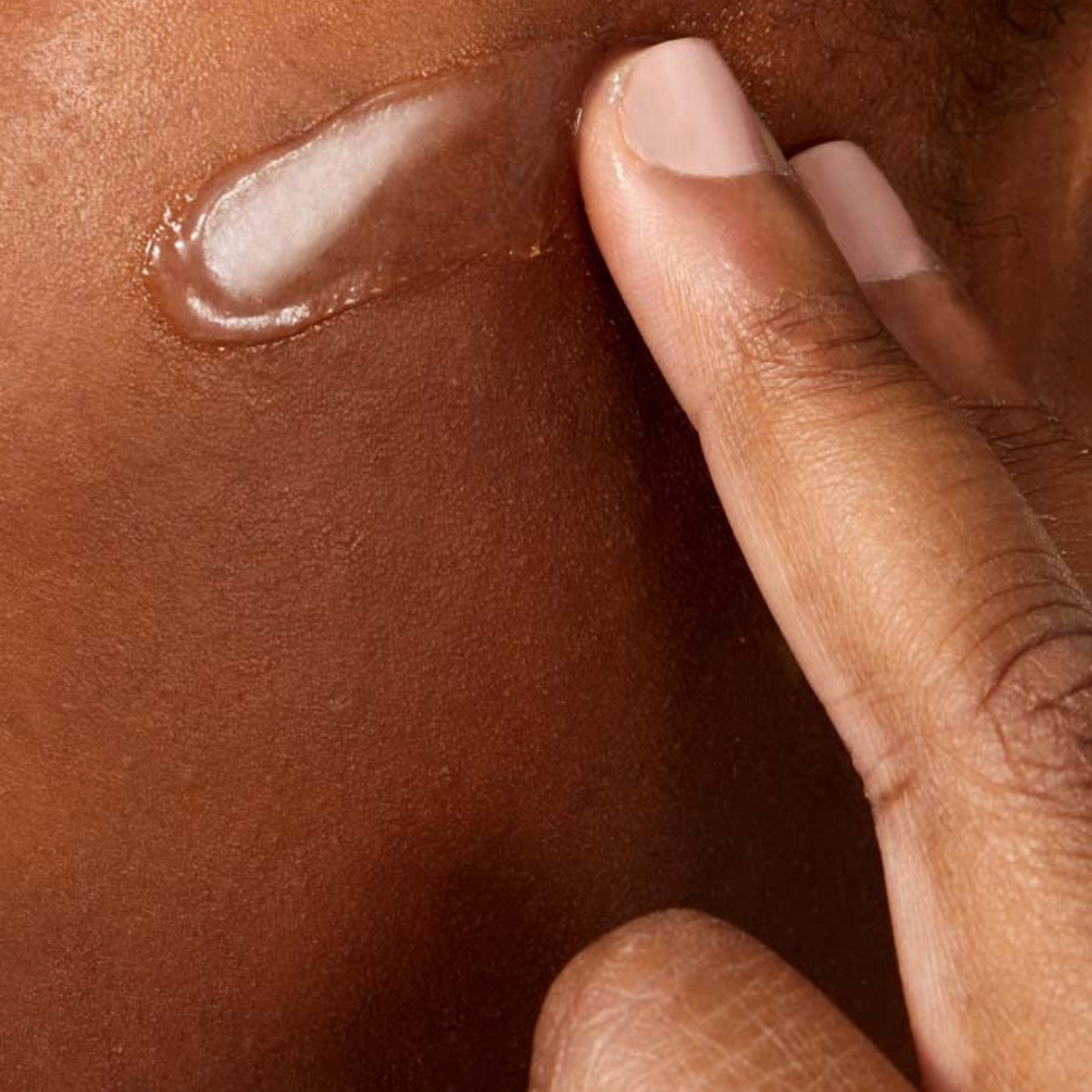 Lumina Pharmacy CeraVe Advanced Repair Ointment being applied to skin, showing the clear, rich, occlusive texture.
